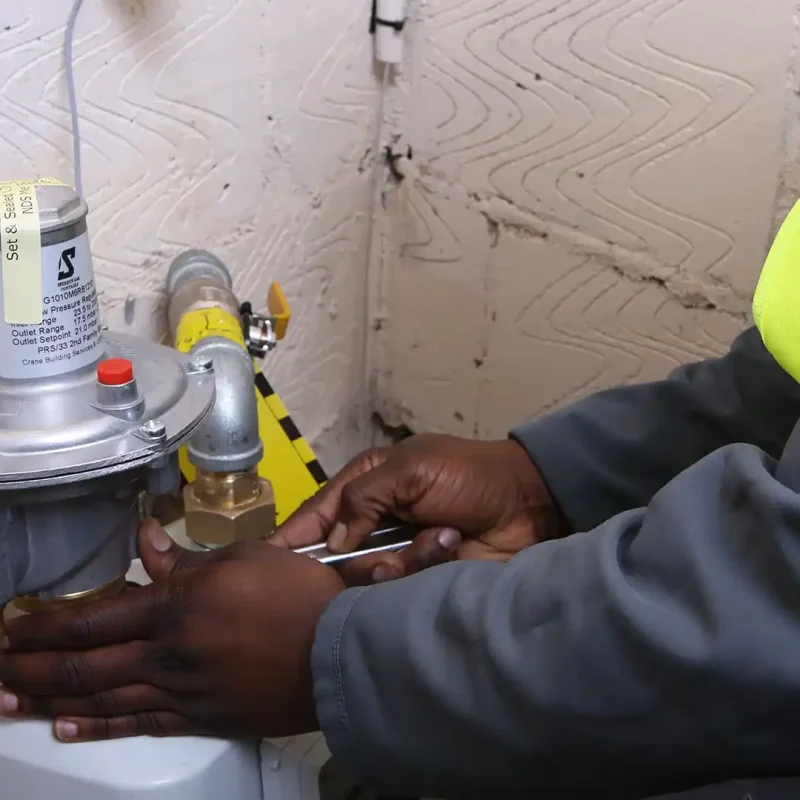 man fixing meter on a wall, meter installation