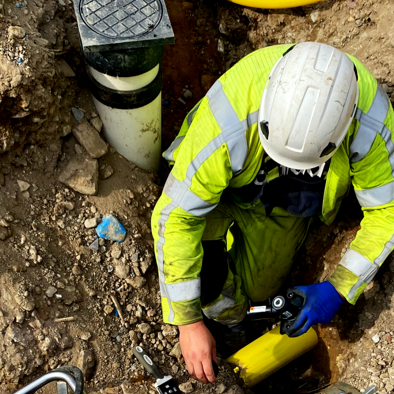 worker in hi vis and protective gear working on live gas