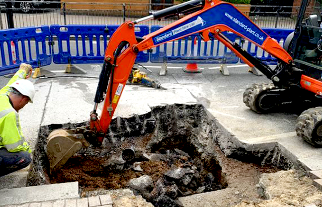 Digging the ground with worker crouching down