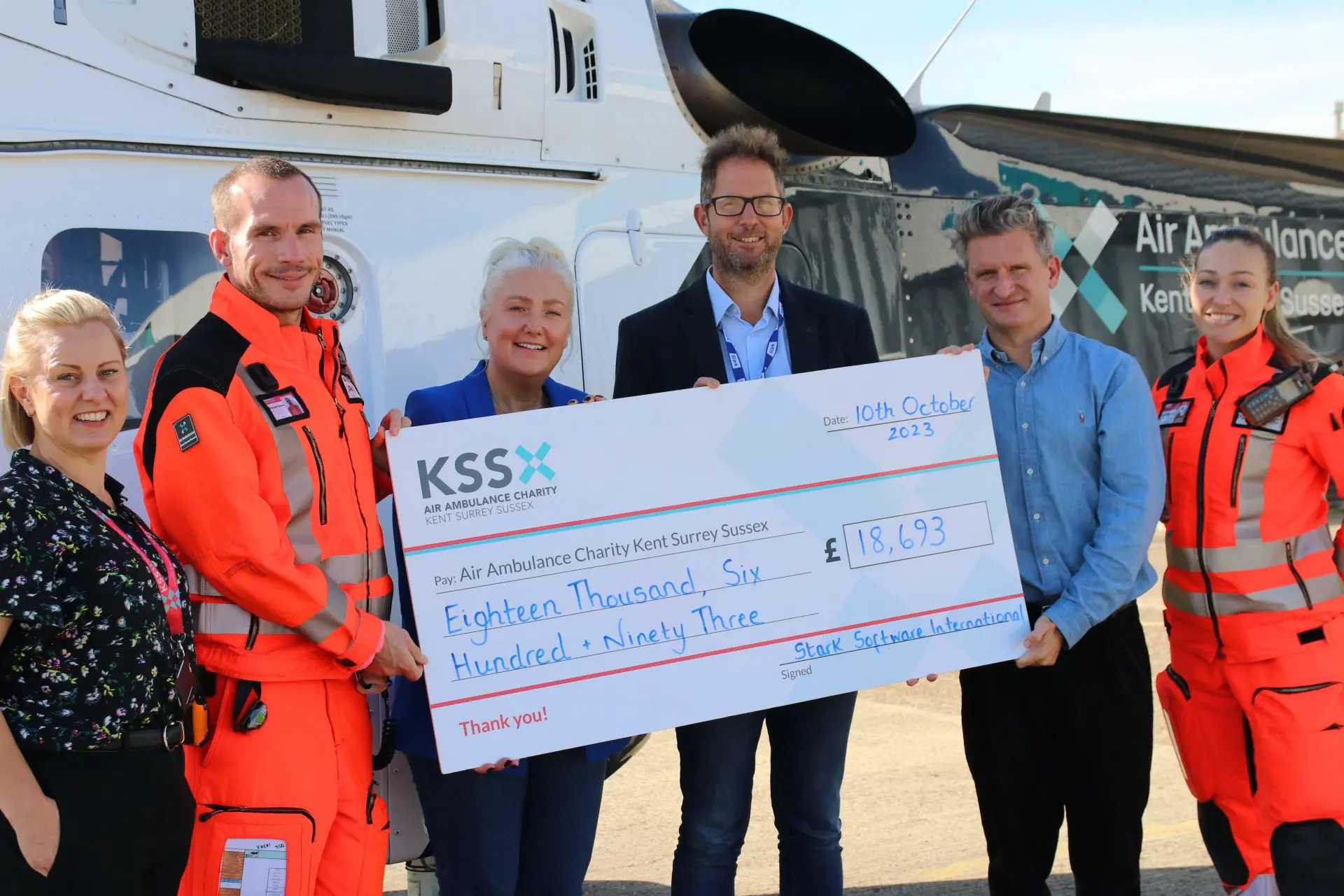 The CEO, Executive Director and Executive Assistant at Stark with the KSS Air Ambulance team. Presenting a cheque of 1£8,693 of the total money Stark has raised for them.