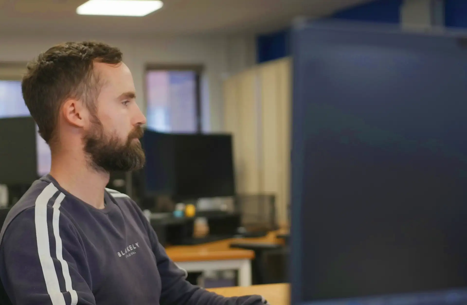 Man looking at computer screen in office