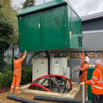 A substation landing with 3 workmen carrying it out